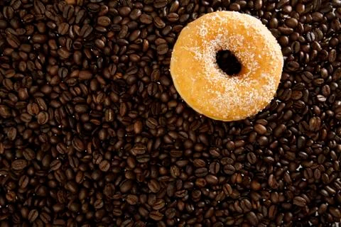Coffee beans and donuts Stock Photos