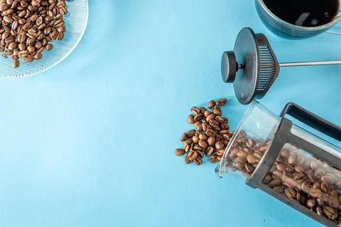 Coffee beans and elements over blue background with copy space o Stock Photos