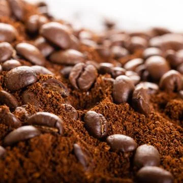 Coffee Beans and Grounds Close up. Background. Stock Photos