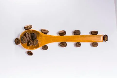 Coffee beans and spoon Stock Photos