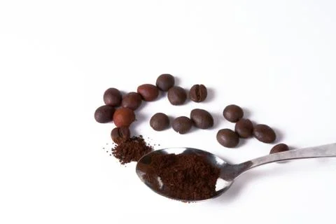 Coffee beans and spoon Stock Photos