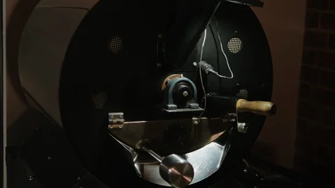 Coffee beans are being mixed inside of a coffee making machine. Vídeo Stock 108064702