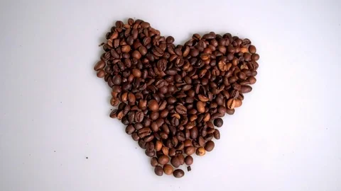 Coffee beans are collected in the shape of a heart on a white background 스톡 동영상 105756391