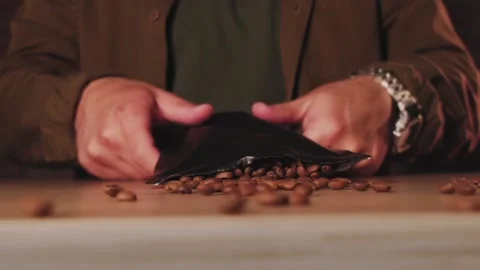Coffee beans are falling in slow motion on the table. Stock Footage 138497953