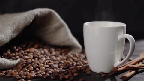 Coffee beans are falling from the top onto a wooden table Stock Footage 146869336