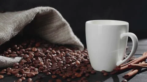 Coffee beans are falling from the top onto a wooden table Stock Footage 146869356