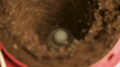 Coffee beans are ground in a coffee grinder, rotating in a circle. Close-up Stock Footage 316089792