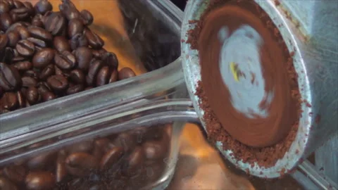 The coffee beans are ground in an old manual coffee grinder. Close-up of Video stock 143902934