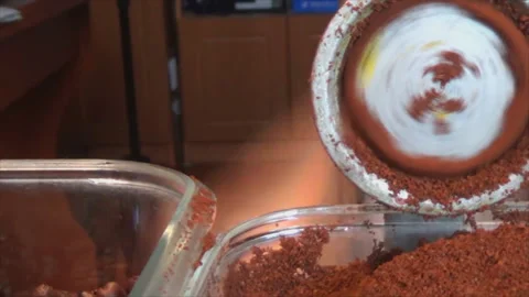 The coffee beans are ground in an old manual coffee grinder. Close-up of Stock-Footage 146178989