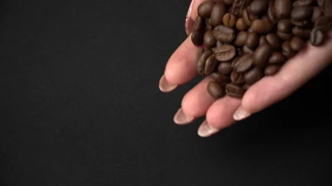 Coffee Beans are Hung Out of Female Hands Stock Footage 170355344