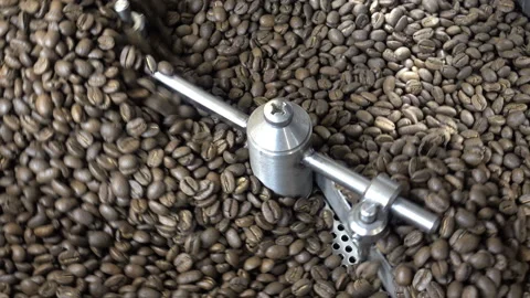 Coffee beans are mixed in the drum of the roasting machine. Video stock 101625685