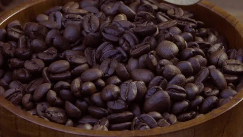 Coffee beans are mixed with a wooden spoon and are collected in a wooden spoon. Stock Footage 79050153