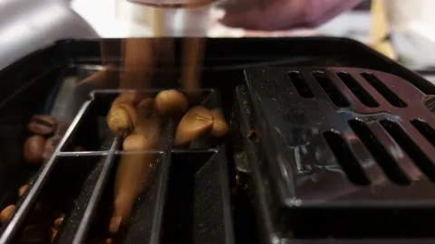 Coffee beans are poured into the coffee machine from above Stock Footage 168701530