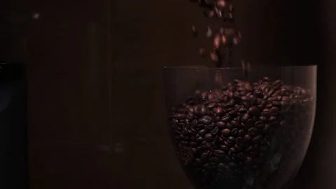 Coffee beans are poured into a coffee grinder slow motion Stock Footage 173174592