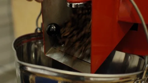 Coffee beans are poured into a container for roasted coffee beans, close-up. Stock Footage 123358726