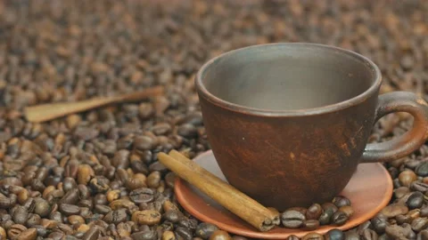 Coffee beans are poured into a dark cup Stock Footage 108610634