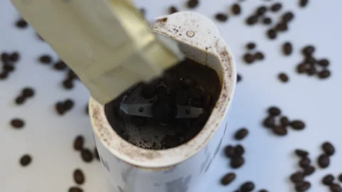 The coffee beans are poured into an electric coffee grinder, ground the coffe Stock Footage 162113455