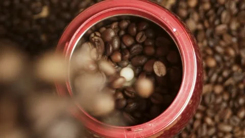 Coffee beans are poured into the grinder against the background of coffee beans Stock Footage 316089699