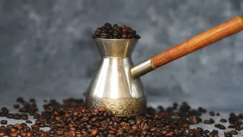 Coffee beans are poured maker and onto the table an iridescent light illuminates Stock Footage 136176128