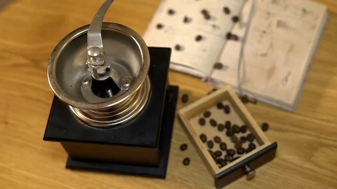 Coffee beans are pured in the old manual coffee grinder. 4K Stock Footage 102548853