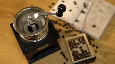 Coffee beans are pured on the table next to the violin. 4K Video stock 102548996