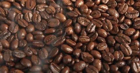 Coffee beans are roasted in a frying pan. Smoke comes from coffee beans Stock Footage 105681675