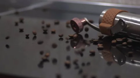 Coffee beans are scattered on the dark colored table. Macro Stock Footage 145792909