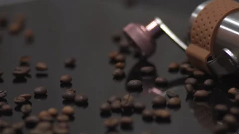 Coffee beans are scattered on the dark colored table. Macro Stock Footage 145792928