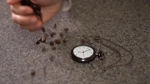 Coffee beans are scattered next to the clock Stock Footage 79656057