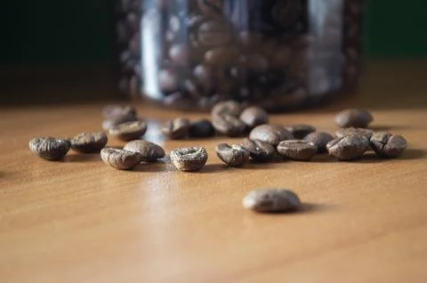 Coffee beans are scattered on the table Stock Photos
