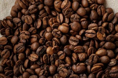 Coffee beans are on table after roasting. Stock Photos