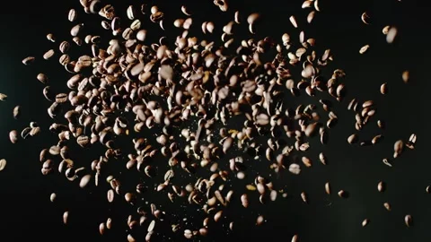 The coffee beans are thrown into the air Stock Footage 253407770