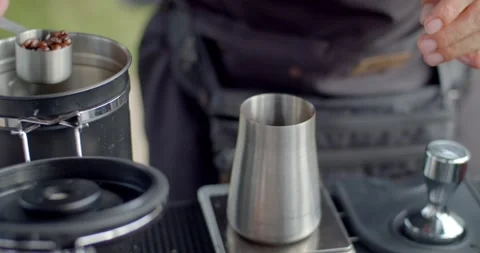 Coffee beans are weighed before grinding to get just the right amount of flavor. Stock Footage 243960323