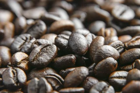 Coffee beans background. Brown roasted coffee beans. Closeup shot of coffee.. Stockfoto's