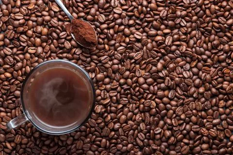 Coffee beans background with coffee beans, a cup of coffee Stockfoto's