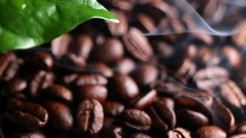 Coffee beans background out of focus with smoke above Stock Footage 162891714