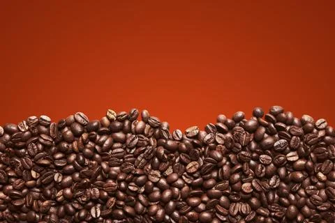 Coffee beans background for poster. Cropped pile of coffee beans. Stock Photos