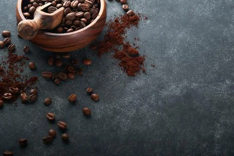 Coffee beans background. Roasted Coffee beans in wooden bamboo bowl on dark b Stock Photos