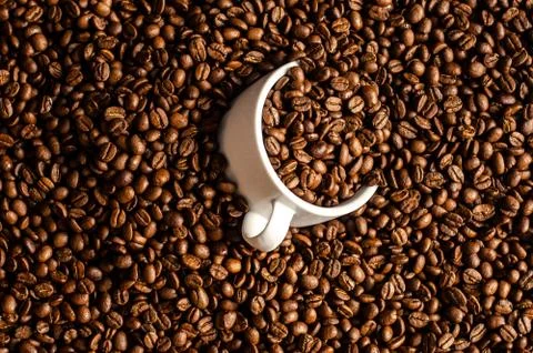 Coffee beans background with white cup, copy space Stock Photos