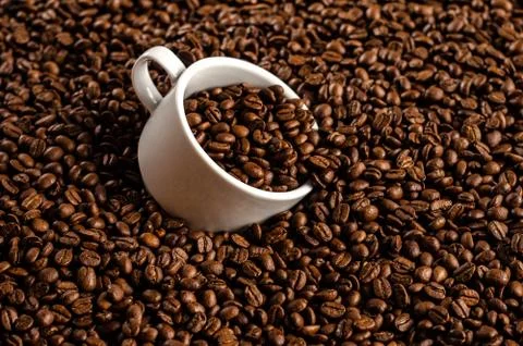 Coffee beans background with white cup, copy space Stock Photos