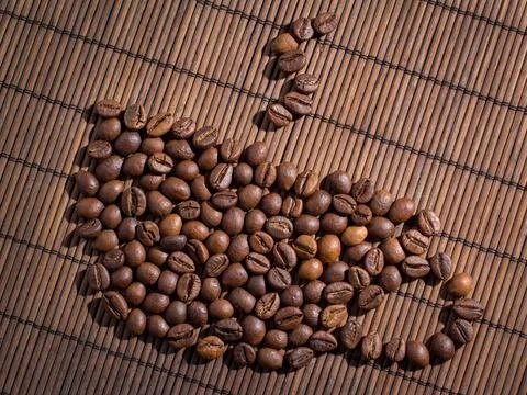 Coffee beans on bamboo mat Stock Photos