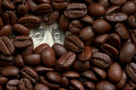 Coffee beans on bank note Stock Photos