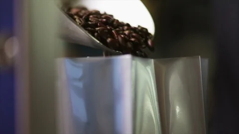 Coffee beans being poured into a bag. Stock-Footage 88405099