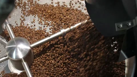 Coffee beans being poured into the mixer during the roasting process Stock Footage 168994448