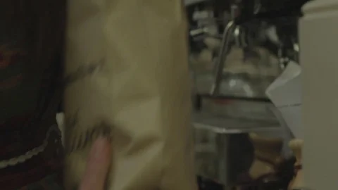Coffee beans being poured out to get ready to brew a pot of coffee Stock Footage 98682229
