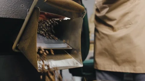 Coffee beans being released from a roasting machine at a local coffee shop Stock-Footage 321763791