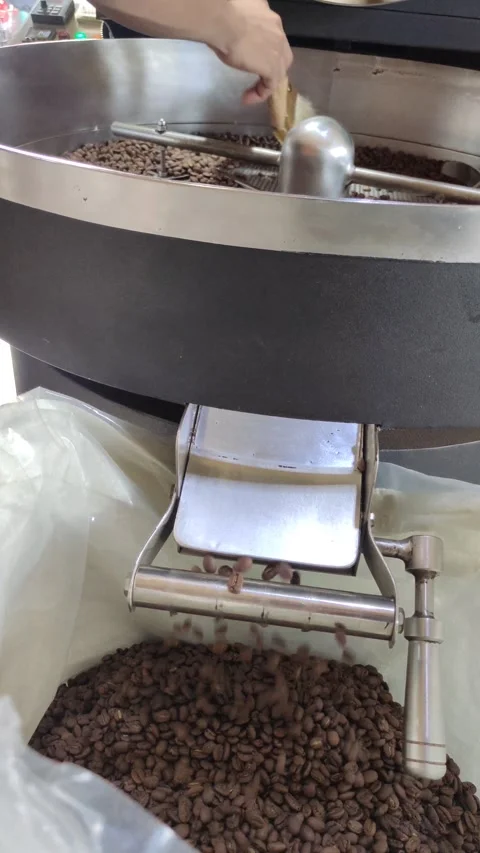 Coffee beans being released through the discharge port Stock Footage 276712697