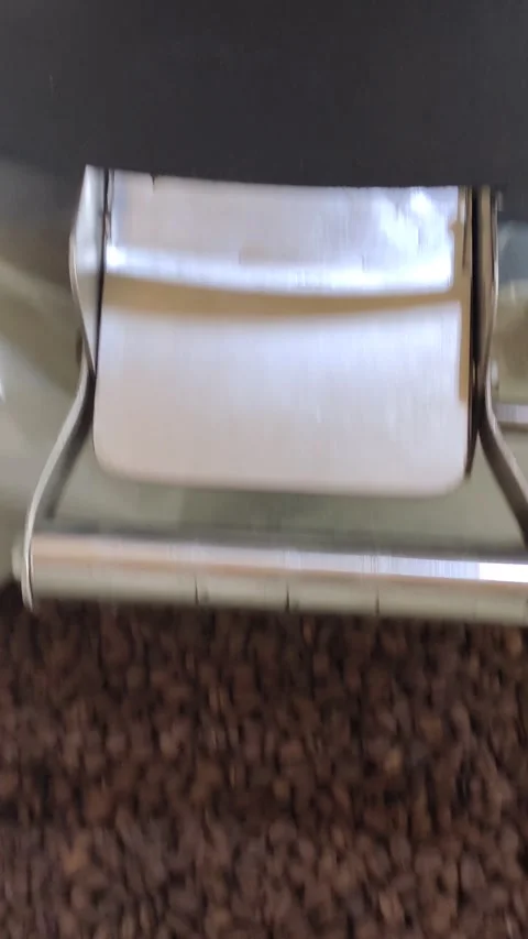 Coffee beans being released through the discharge port Stock Footage 276712706