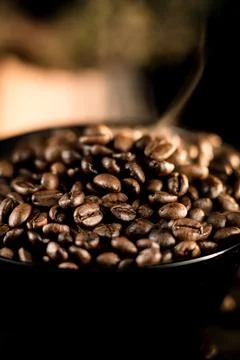 Coffee beans on a black background. Close-up of coffee grains. Stock Photos