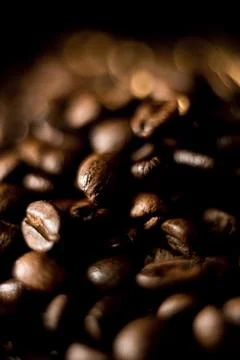 Coffee beans on a black background. Close-up of coffee grains. Stock Photos